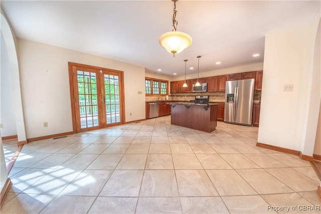 319 Parrotts Cove Rd, Water View, VA 23180 - kitchen with appliances with stainless steel finishes, a center island, backsplash, baseboards, and recessed lighting