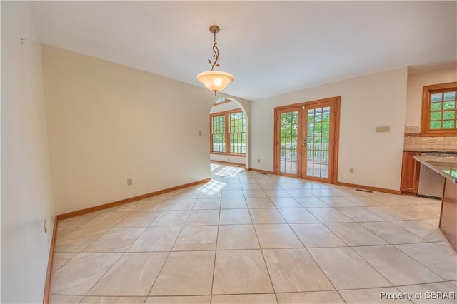 319 Parrotts Cove Rd, Water View, VA 23180 - empty room featuring plenty of natural light, baseboards, light tile patterned floors, and french doors