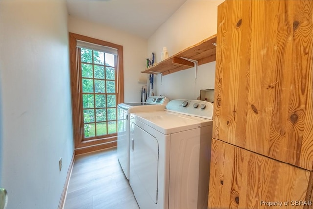 319 Parrotts Cove Rd, Water View, VA 23180 - washroom featuring washing machine and clothes dryer, baseboards, and light wood-style floors