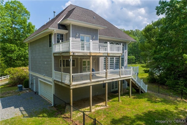 319 Parrotts Cove Rd, Water View, VA 23180 - rear view of house featuring a shingled roof, driveway, stairway, a wooden deck, and an attached garage
