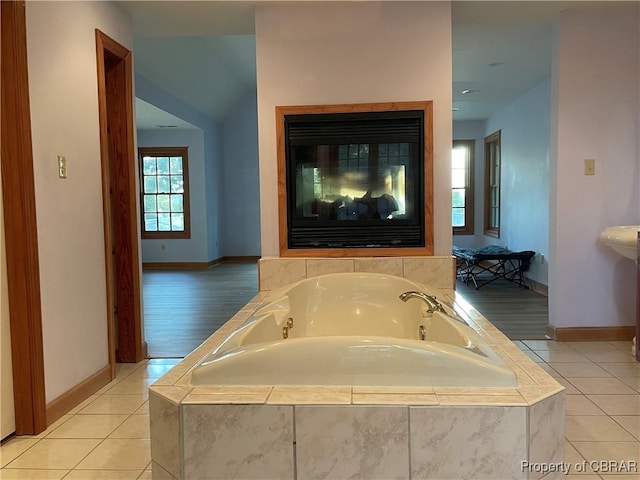 319 Parrotts Cove Rd, Water View, VA 23180 - bathroom with baseboards, a bath, and tile patterned floors