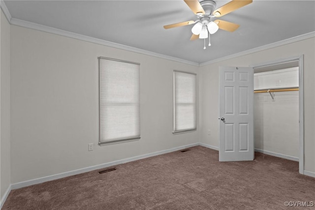 unfurnished bedroom featuring carpet flooring, crown molding, baseboards, a closet, and ceiling fan