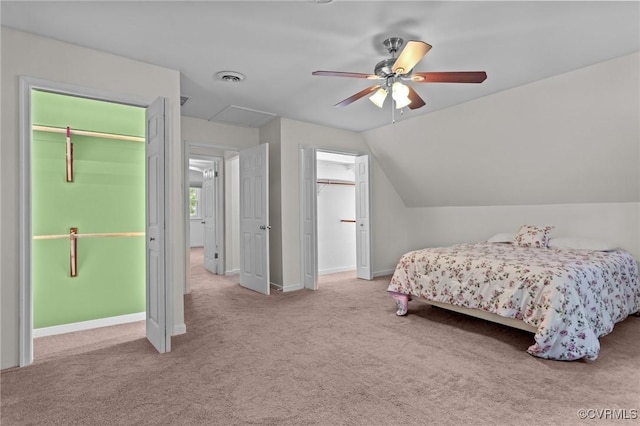 bedroom with carpet, vaulted ceiling, baseboards, and ceiling fan