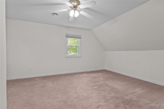 additional living space with carpet, baseboards, vaulted ceiling, and a ceiling fan