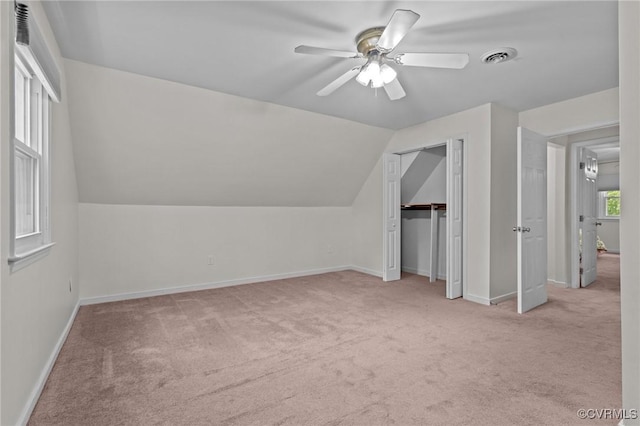 additional living space featuring carpet flooring, a ceiling fan, baseboards, and lofted ceiling