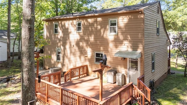 rear view of property with a deck and central AC
