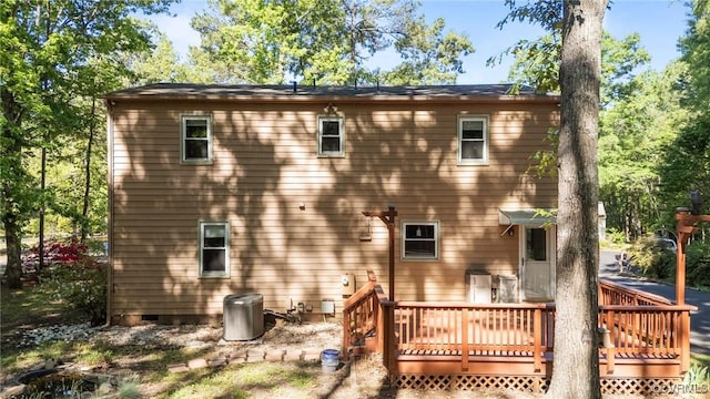rear view of house with a deck and crawl space