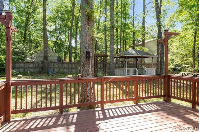 wooden deck with a fenced backyard and a gazebo