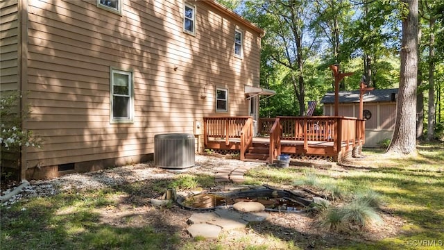 back of house featuring central AC unit, crawl space, and a wooden deck