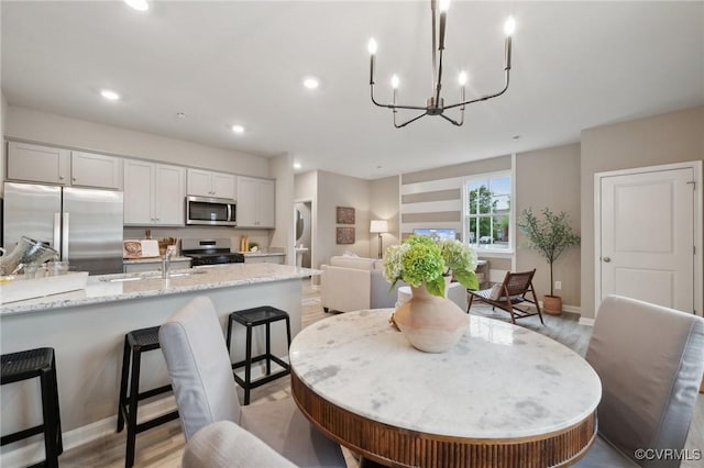 6024 Banyan Ln, Chesterfield, VA 23234 - dining room with a chandelier, light wood-style floors, baseboards, and recessed lighting