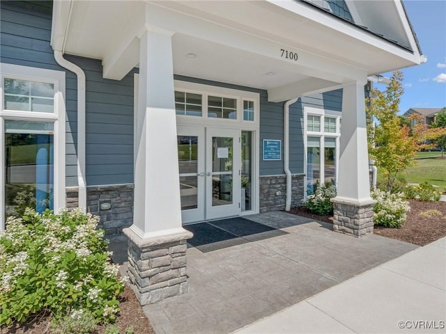 6024 Banyan Ln, Chesterfield, VA 23234 - view of exterior entry featuring stone siding, french doors, and a porch