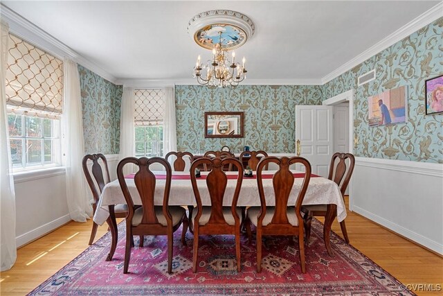 204 College Ave, Ashland, VA 23005 - dining room with wallpapered walls, light wood finished floors, a chandelier, and crown molding