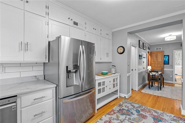 204 College Ave, Ashland, VA 23005 - kitchen featuring stainless steel appliances, light wood finished floors, white cabinetry, backsplash, and crown molding
