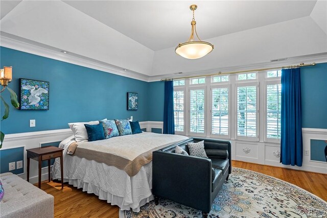 204 College Ave, Ashland, VA 23005 - bedroom featuring a wainscoted wall, wood finished floors, and a raised ceiling