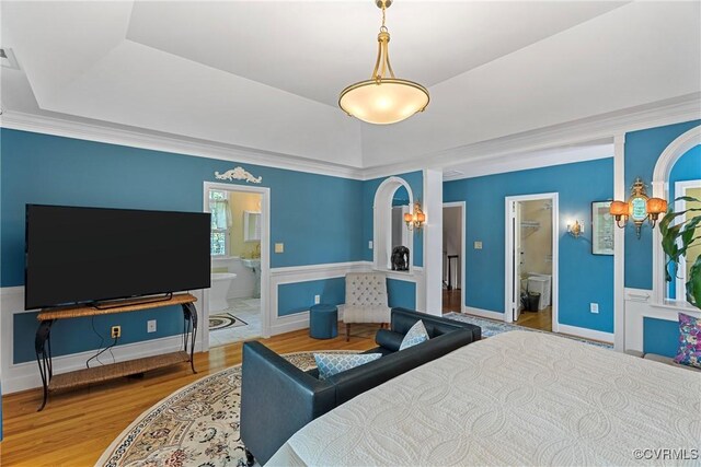 204 College Ave, Ashland, VA 23005 - bedroom with a raised ceiling, wood finished floors, connected bathroom, a chandelier, and crown molding