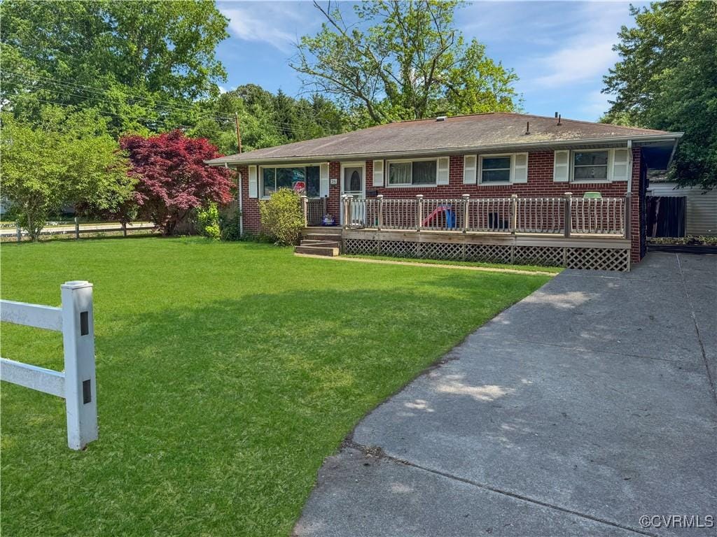 ranch-style house with a front lawn and brick siding