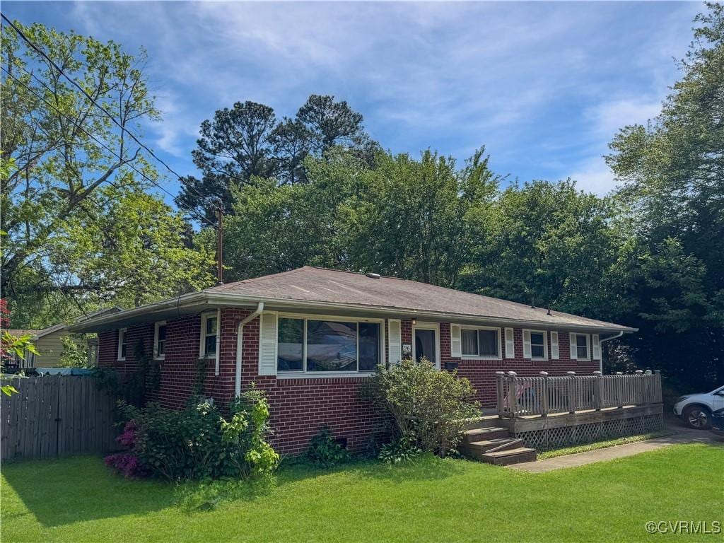 view of front of property with brick siding and a wooden deck