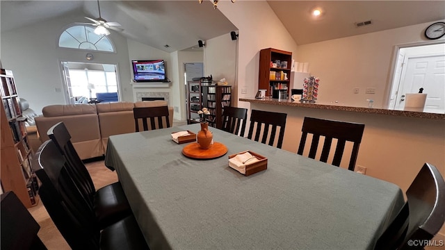 7211 Norwood Pond Ct, Midlothian, VA 23112 - dining room featuring ceiling fan, high vaulted ceiling, a fireplace, and light carpet