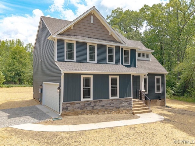 view of front of property with a shingled roof, driveway, a garage, and stone siding