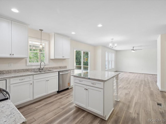 kitchen with dishwasher, a sink, healthy amount of natural light, light wood-style flooring, and recessed lighting