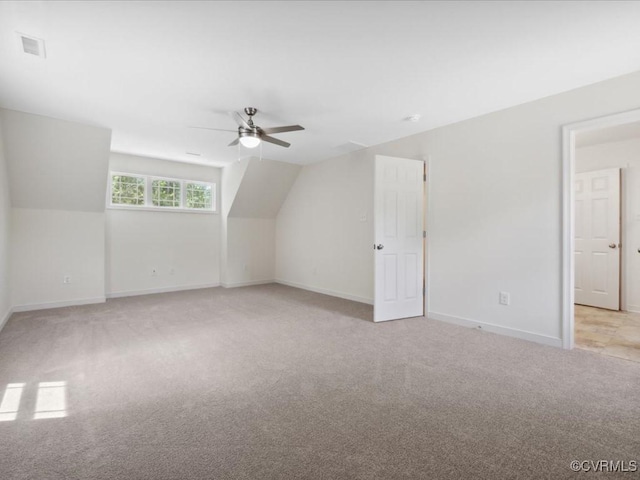 bonus room featuring light colored carpet, ceiling fan, baseboards, and lofted ceiling