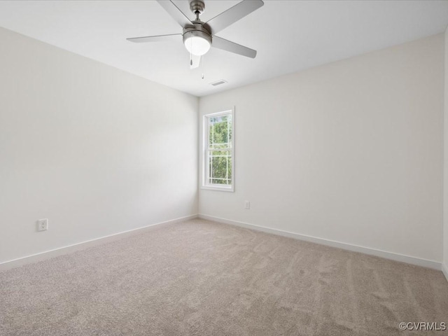 unfurnished room with light carpet, baseboards, and ceiling fan