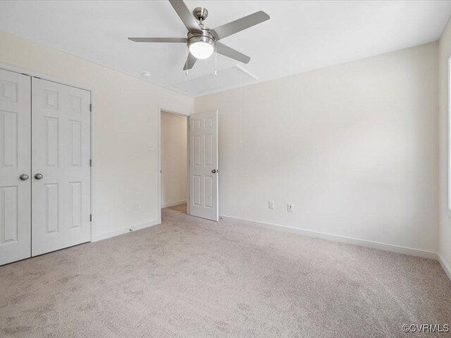 unfurnished bedroom with carpet flooring, baseboards, a closet, and ceiling fan