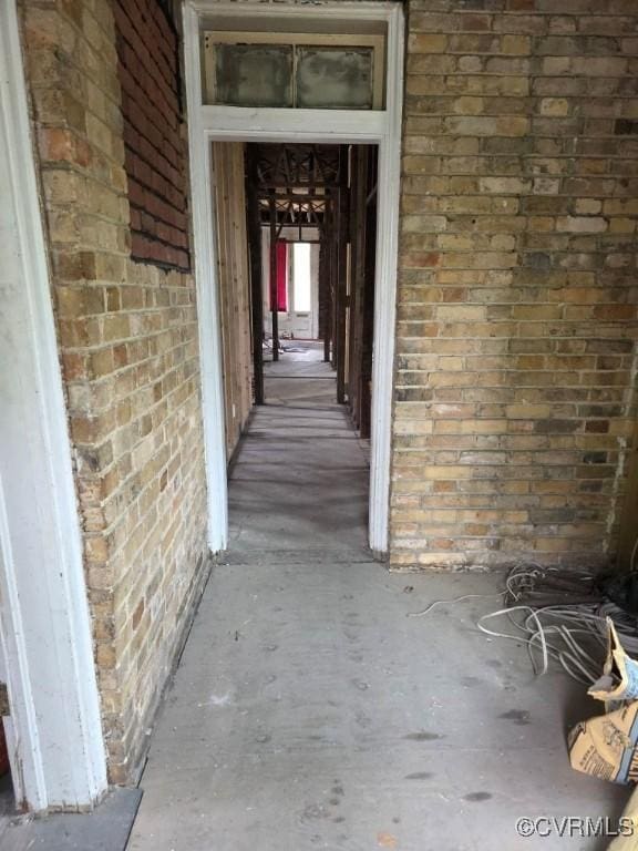 property entrance featuring brick siding