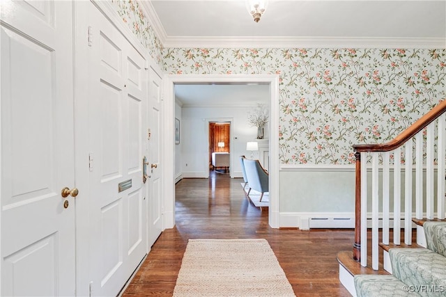 foyer featuring wallpapered walls, ornamental molding, dark wood-type flooring, a baseboard radiator, and baseboards