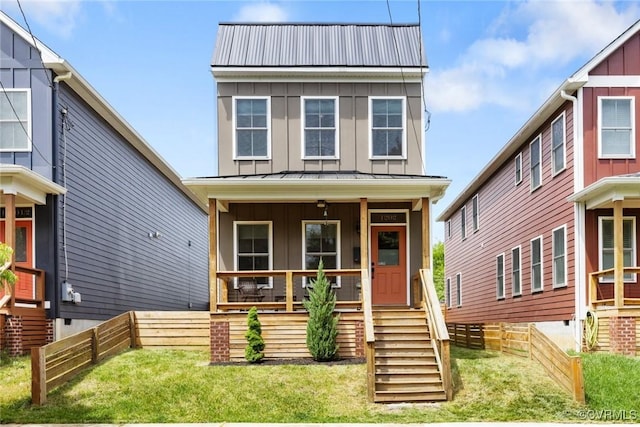 view of front of property featuring board and batten siding, covered porch, and metal roof