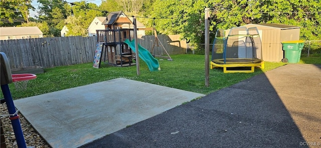 view of yard with a trampoline, a playground, and a patio