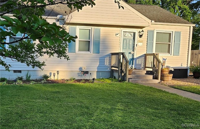 bungalow-style house featuring a front lawn, crawl space, and roof with shingles
