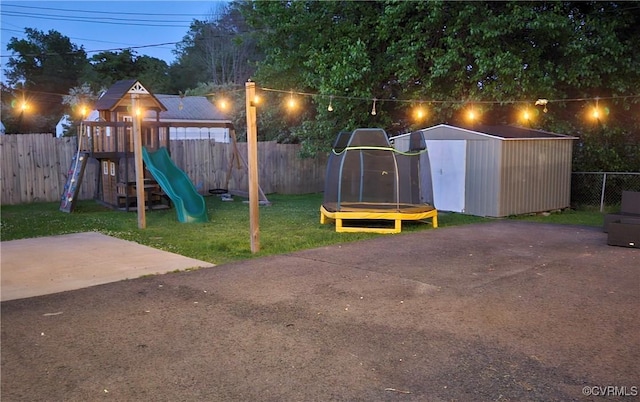 view of playground with a storage shed, an outbuilding, and a trampoline