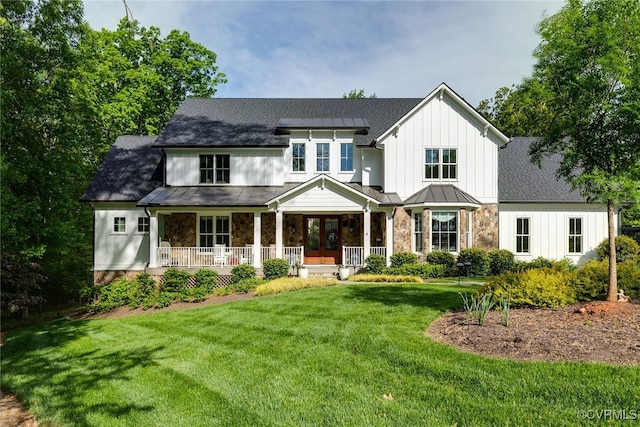 8 Nomas Ln, Henrico, VA 23238 - view of front of house featuring covered porch, stone siding, a front lawn, a standing seam roof, and board and batten siding