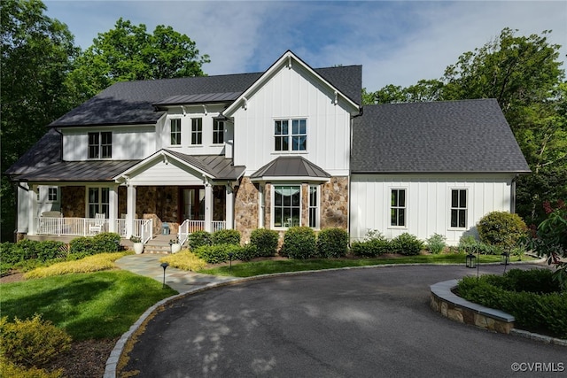 8 Nomas Ln, Henrico, VA 23238 - modern farmhouse style home featuring a standing seam roof, stone siding, board and batten siding, a porch, and metal roof