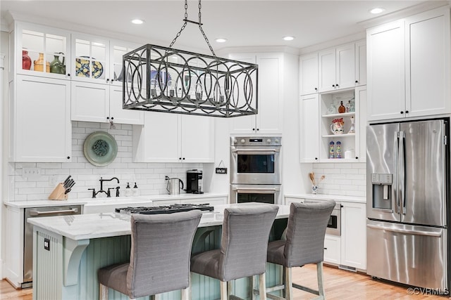 8 Nomas Ln, Henrico, VA 23238 - kitchen with stainless steel appliances, a sink, white cabinets, backsplash, and a breakfast bar