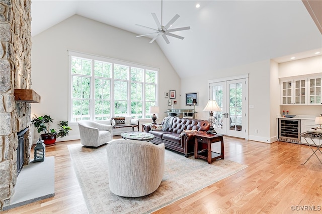 8 Nomas Ln, Henrico, VA 23238 - living room featuring wine cooler, high vaulted ceiling, a stone fireplace, ceiling fan, and light wood finished floors