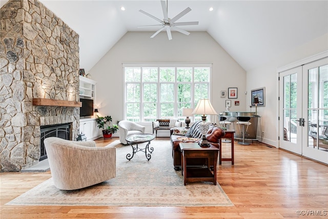 8 Nomas Ln, Henrico, VA 23238 - living area featuring high vaulted ceiling, a ceiling fan, light wood-style floors, french doors, and a stone fireplace