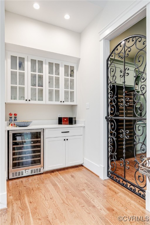 8 Nomas Ln, Henrico, VA 23238 - indoor dry bar with wine cooler, light wood-style floors, and recessed lighting