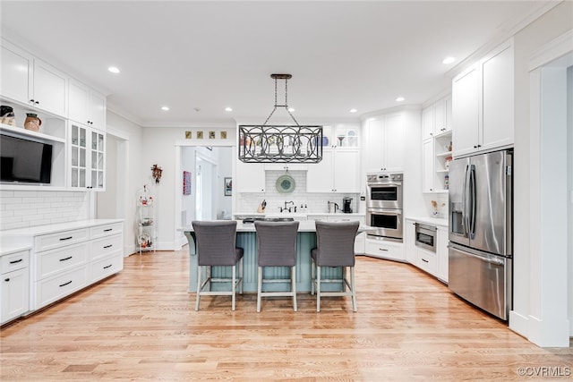 8 Nomas Ln, Henrico, VA 23238 - kitchen with appliances with stainless steel finishes, white cabinets, decorative backsplash, a kitchen bar, and light countertops