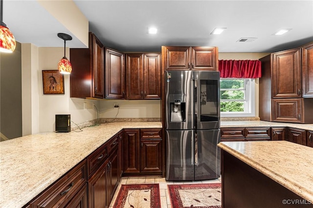 5541 Cedar Ln, Amelia Courthouse, VA 23002 - kitchen featuring stainless steel fridge, hanging light fixtures, light stone countertops, and dark brown cabinetry