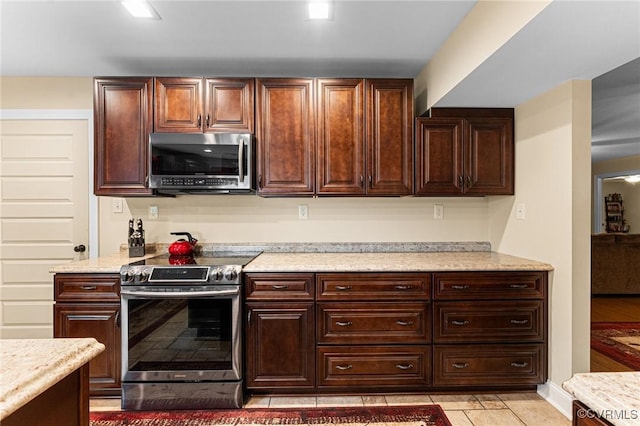 5541 Cedar Ln, Amelia Courthouse, VA 23002 - kitchen with stainless steel appliances, light tile patterned floors, and dark brown cabinets