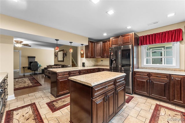 5541 Cedar Ln, Amelia Courthouse, VA 23002 - kitchen with stainless steel refrigerator with ice dispenser, light countertops, open floor plan, pendant lighting, and a peninsula