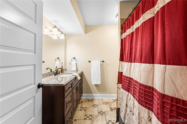 5541 Cedar Ln, Amelia Courthouse, VA 23002 - full bathroom featuring stone finish floors, vanity, baseboards, and curtained shower