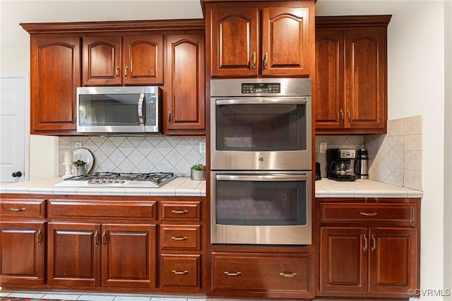 5541 Cedar Ln, Amelia Courthouse, VA 23002 - kitchen featuring appliances with stainless steel finishes, backsplash, and tile counters