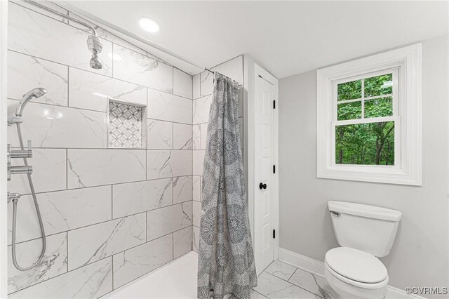 5541 Cedar Ln, Amelia Courthouse, VA 23002 - bathroom featuring baseboards, marble look tiles, tiled shower, and toilet