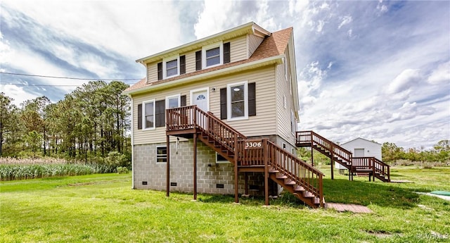 back of property featuring stairs and a yard