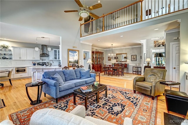 645 Farnham Cir, North Chesterfield, VA 23236 - living room with a high ceiling, light wood-style flooring, a ceiling fan, ornamental molding, and a chandelier