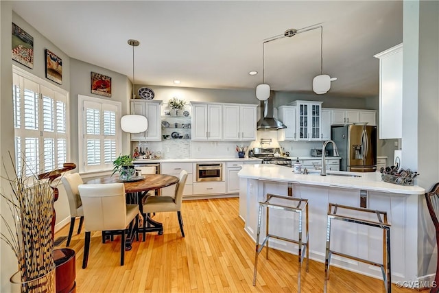 645 Farnham Cir, North Chesterfield, VA 23236 - kitchen with wall chimney exhaust hood, appliances with stainless steel finishes, a sink, a peninsula, and glass insert cabinets