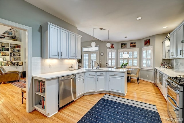 645 Farnham Cir, North Chesterfield, VA 23236 - kitchen with appliances with stainless steel finishes, a sink, a peninsula, light wood-type flooring, and recessed lighting